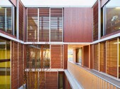 View into the inner courtyard: Filigree wooden sliding elements protect from the sun